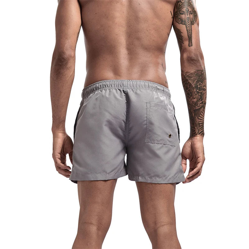 Maillot de bain pour hommes avec doublure en maille poches latérales short de plage solide séchage rapide léger cordon de serrage short de bain maillot de bain d'été